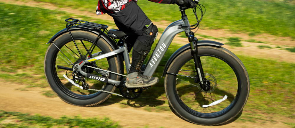 Rider on Aventon electric bike on dirt trail