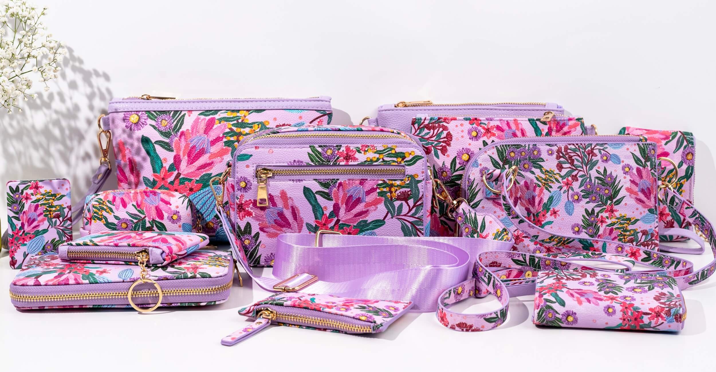 A collection of bags and purses with artwork Celebration by Indigenous artist  Alkina Edwards