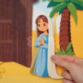 Close up on a Virgin Mary felt cutout with the Nativity Wallboard visible in the background.