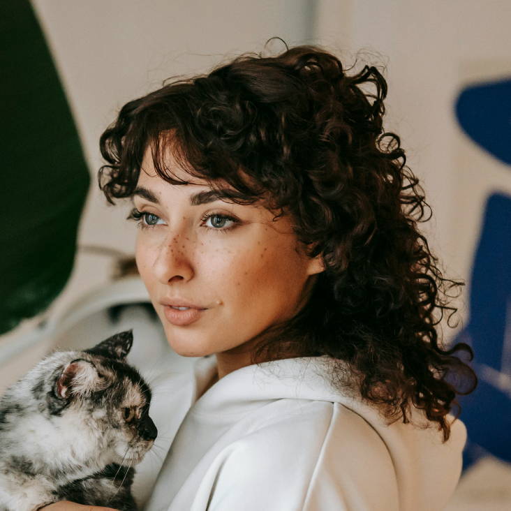 woman with curly dark brown hair with bangs