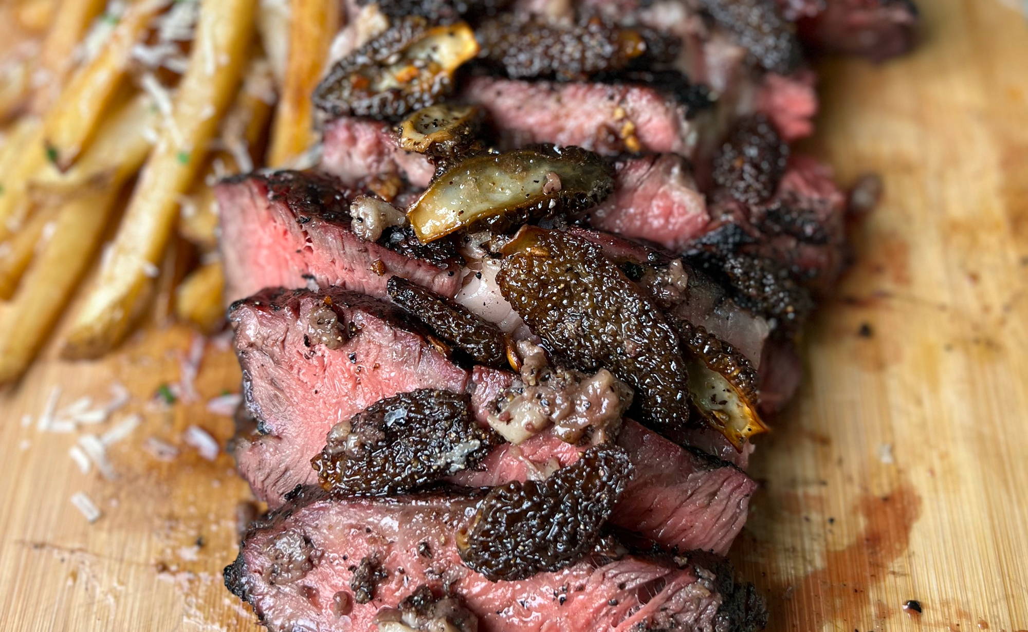 BetterFed Beef Certified ONYA® Tomahawk Ribeye Steak with bone marrow, morel mushrooms, and french fries