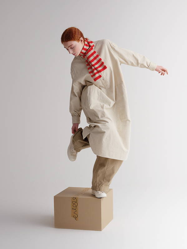 model wears Small Pointelle Stripe Scarf Poppy & Oatmeal