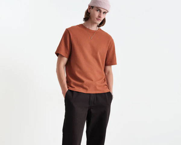 Man wearing rust red t-shirt from 220gsm organic cotton made by UK men's sustainable clothing brand Wax london
