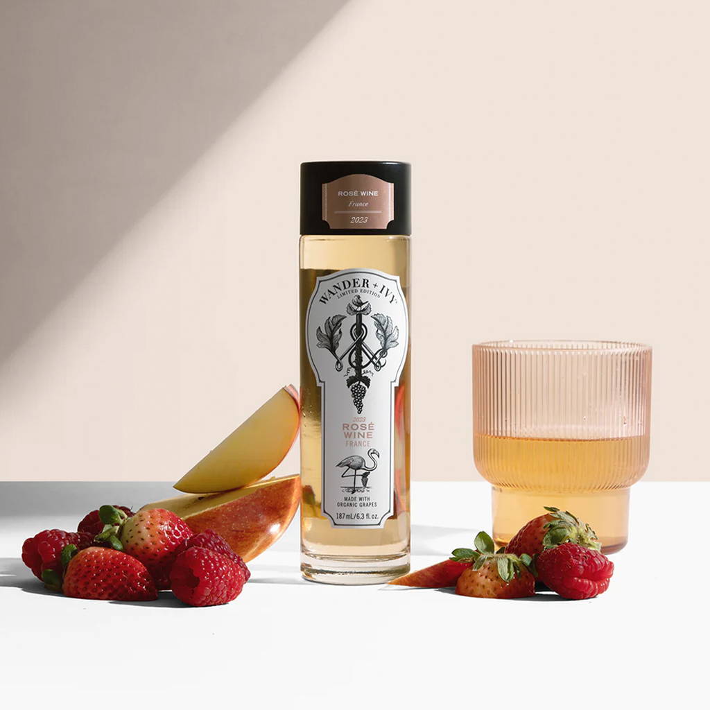 A single-serve bottle of Rosé with sliced apples and strawberries