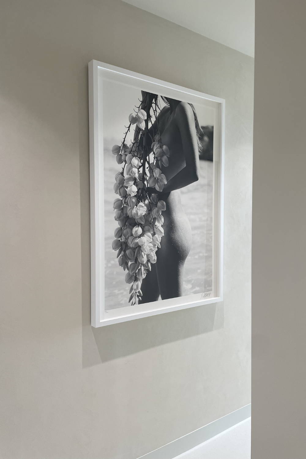 'Under My Skin' by Dina Broadhurst - A black and white photographic print of a nude figure covered by a foliage branch
