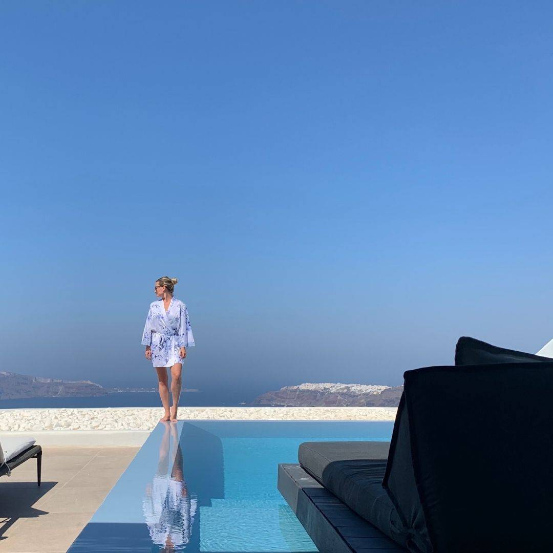 Cavotagoo infinity pool overlooking Santorini caldera at sunset