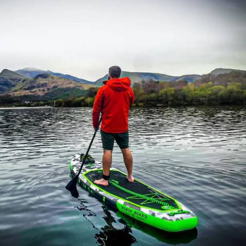 Boy stand up paddleboarding in Manitoba