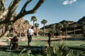 Golfer taking a tee shot at a scenic golf resort course