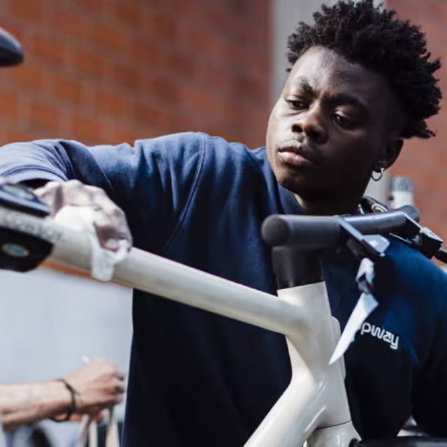 man wiping down his bike frame