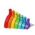 Montessori Rainbow toy pieces lined up from biggest to smallest, with pegs standing on top of the arches. 