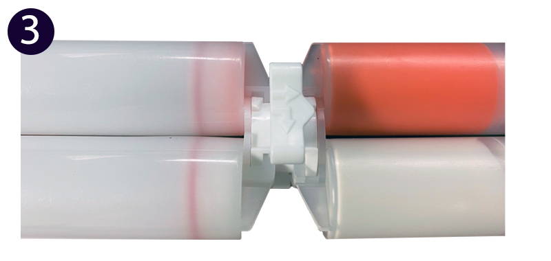 Picture of extruding the remaining material into the recipient cartridge.