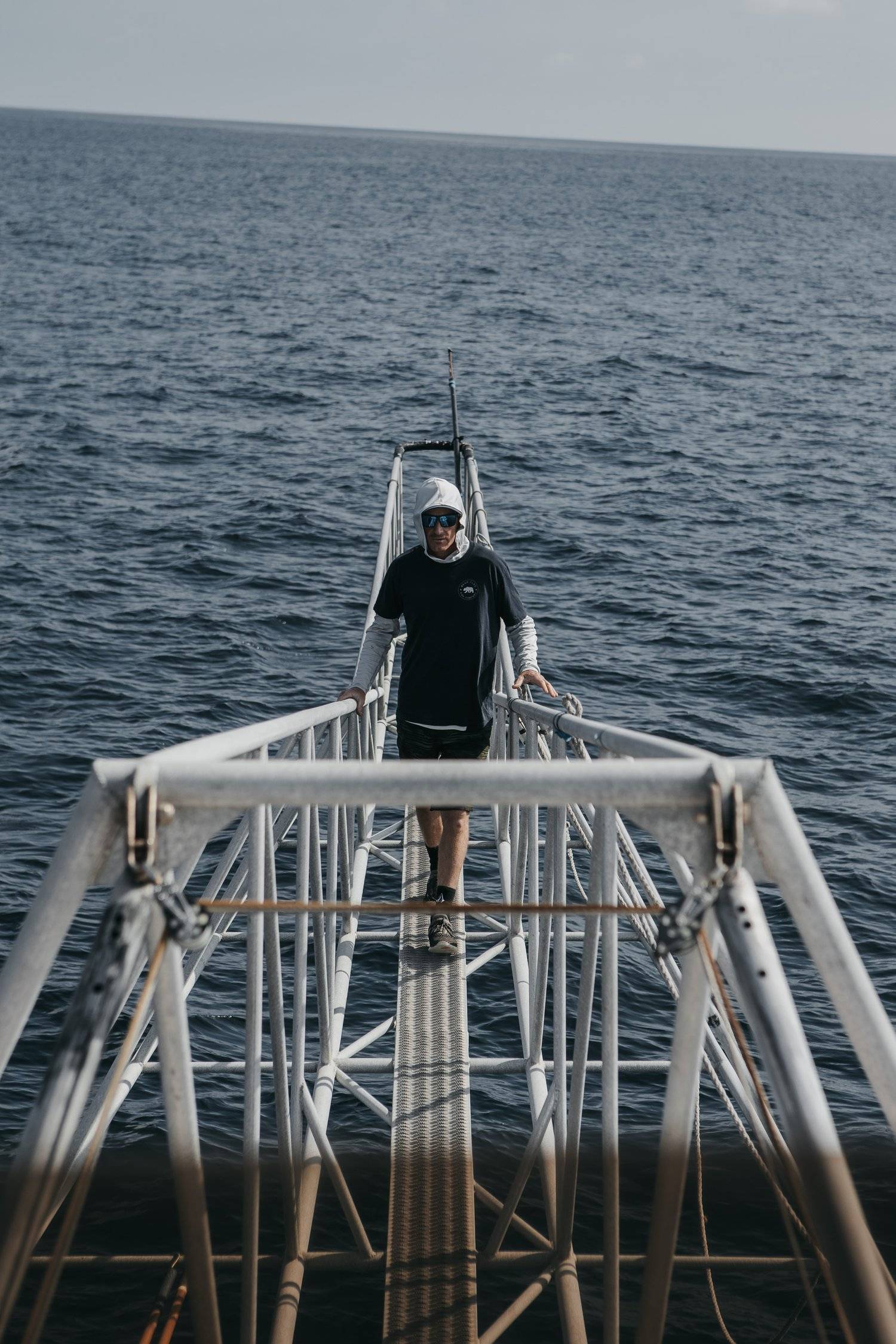 An image of a bear flag crew member standing on the boat. 