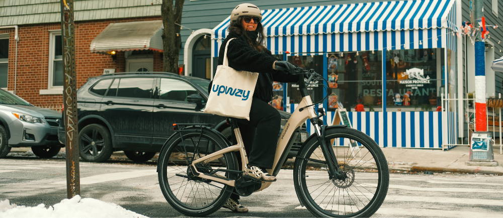 Woman riding a Specialized electric hybrid bike in snowy New York City