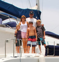 The Leonards, Mandi and Scott, and their three sons/crew Luke, Jake and Griffen on Leonard's floating RIA, Three Little Birds.