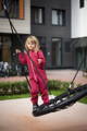Girl standing on the side of the balance swing