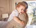 Parent holding and comforting a crying toddler during an emotional moment.