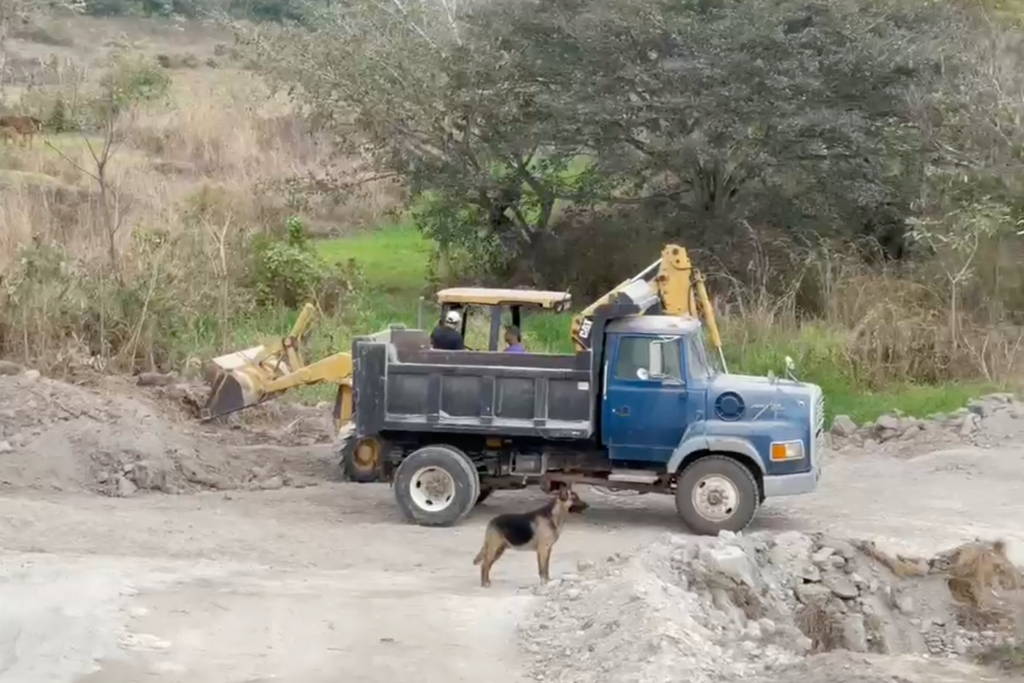 Dump truck and bulldozer building a water reservoir. 