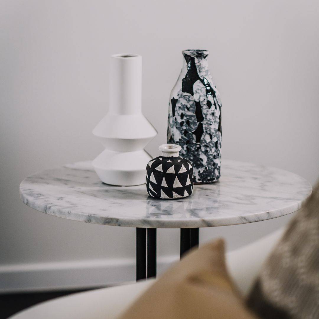 marble side table with three geometric vases