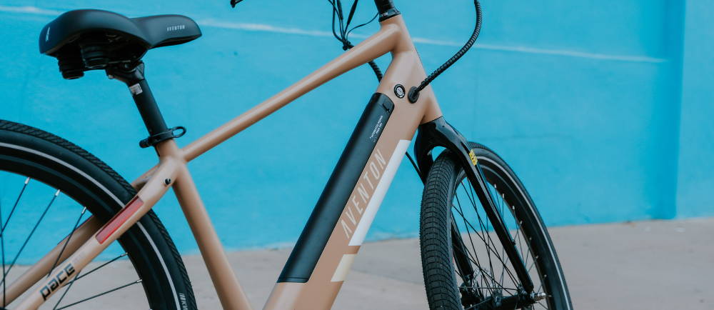 A brown Aventon Pace 500.2 against a blue wall