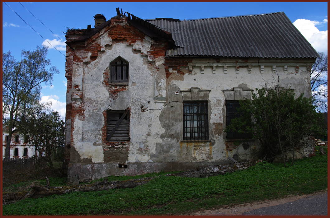 Historic building with severe masonry damage, exposed brick, and cracked plaster—showing clear signs of deterioration and restoration needs.