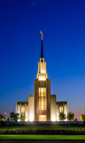 Vertical picture of TWin Falls TEmple glowing against an evening sky. 