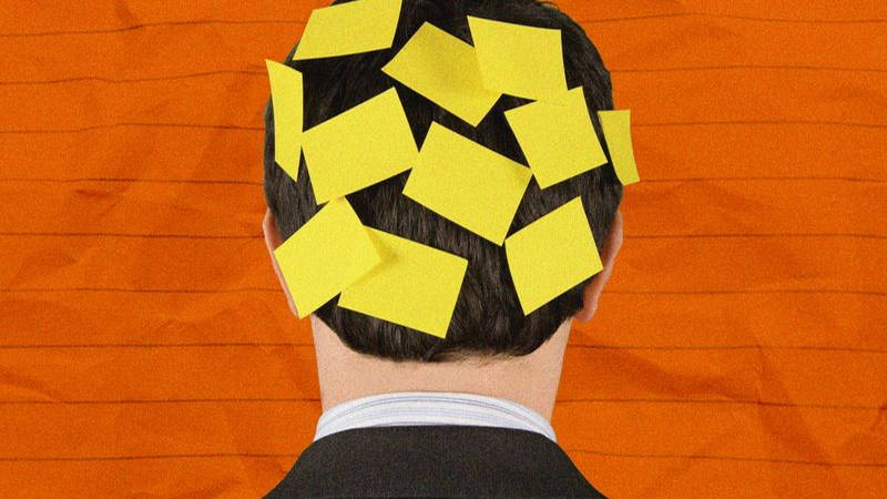 Post it notes on the back of a man's ahead