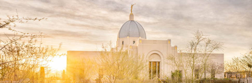 Banner image of the Tucson Temple with the sun shining out from behind the wall.