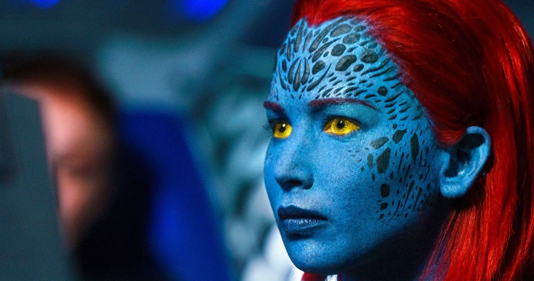 Jennifer Lawrence as Mystique, looking at someone off camera in her natural form.