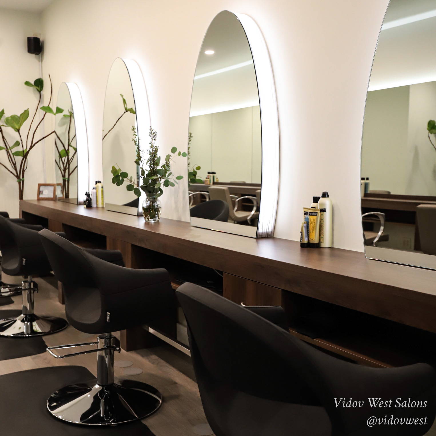 chic salon front desk with red shelves that have Davines Essential Haircare products