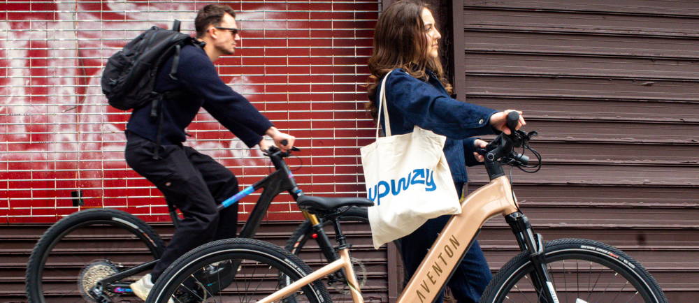 man and woman riding electric bikes in the city