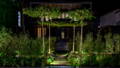 patina copper spike lights bring warmth and texture to surrounding greenery, blending naturally into the landscape by Havit Lighting.