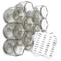 A group of glass spice jars with metal lids next to a list of spice labels on a white background