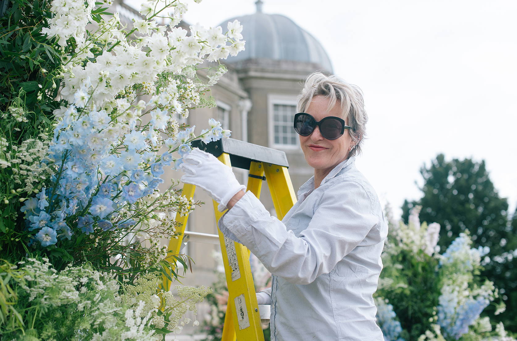 Nikki Tibbles, Founder of Wild at Heart creating a floral column for a wedding at Wrotham Park