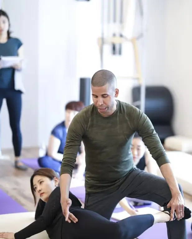 Photo of Brett helping students during Mat work