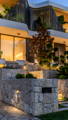 Havit outdoor lighting softly washing stone steps and landscaped entry.