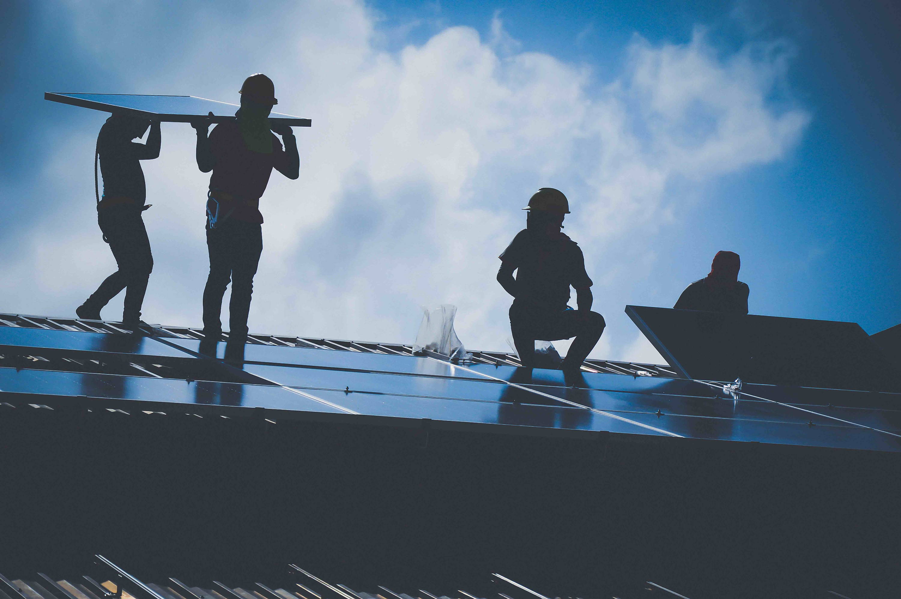 Workers installing solar panels