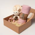 Montessori Baby Shower Gift featuring a crochet bunny teething toy, a blanket, pacifier, and a brush in an eco-friendly box.