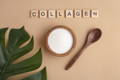small wooden bowl of white collagen powder below the word collagen spelled out in Scrabble tiles