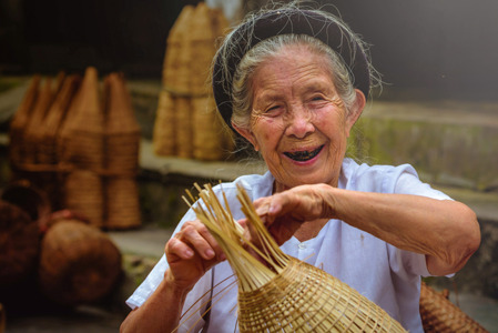 Vietnamese fishermen are doing basketry for fishing equipment at morning.jpg