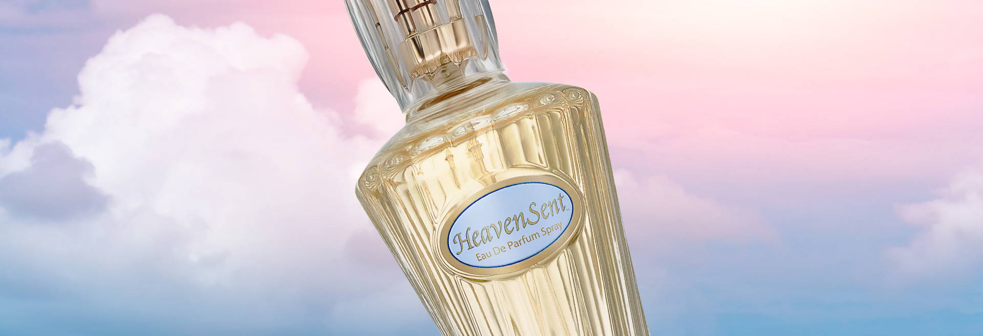 Bottle of Heaven Sent eau de parfum on pink, purple clouds in sky