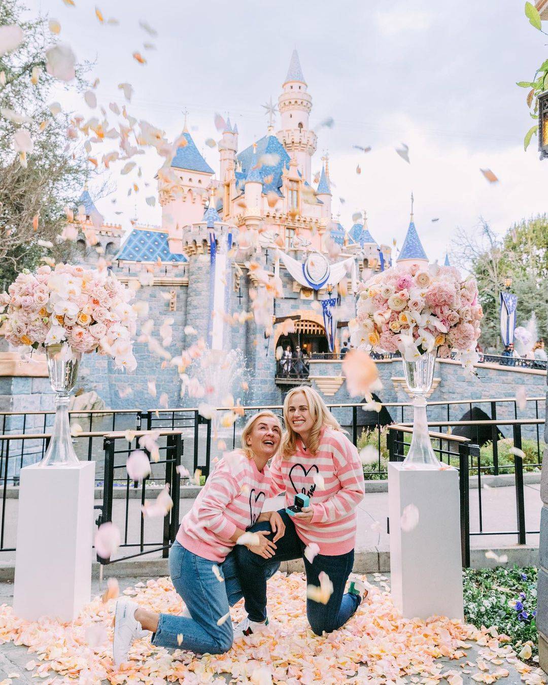 Photo by Rebel Wilson on February 19, 2023. An image of 2 people holding hands with a sparkling engagement ring on display at Disney World Resort