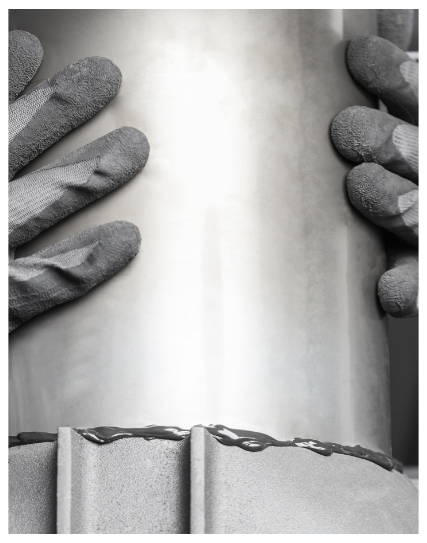 Improperly fitted metal chimney chase lid with visible seam and poor sealing around the flue