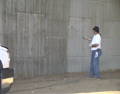 applying antigraffiti coating to freeway cement walls