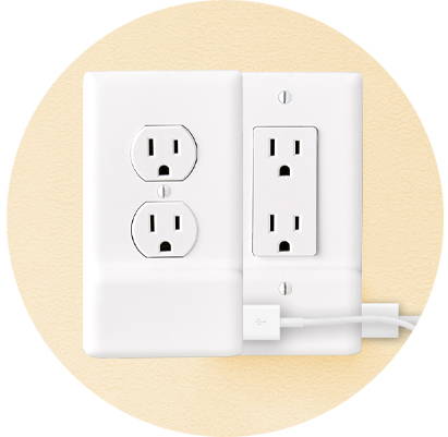 Two USB charger outlet pates against a yellow wall