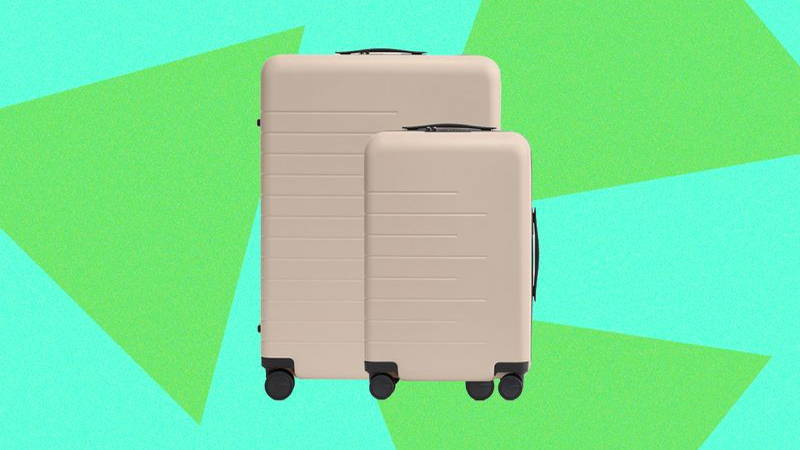 Two beige luggage containers with wheels