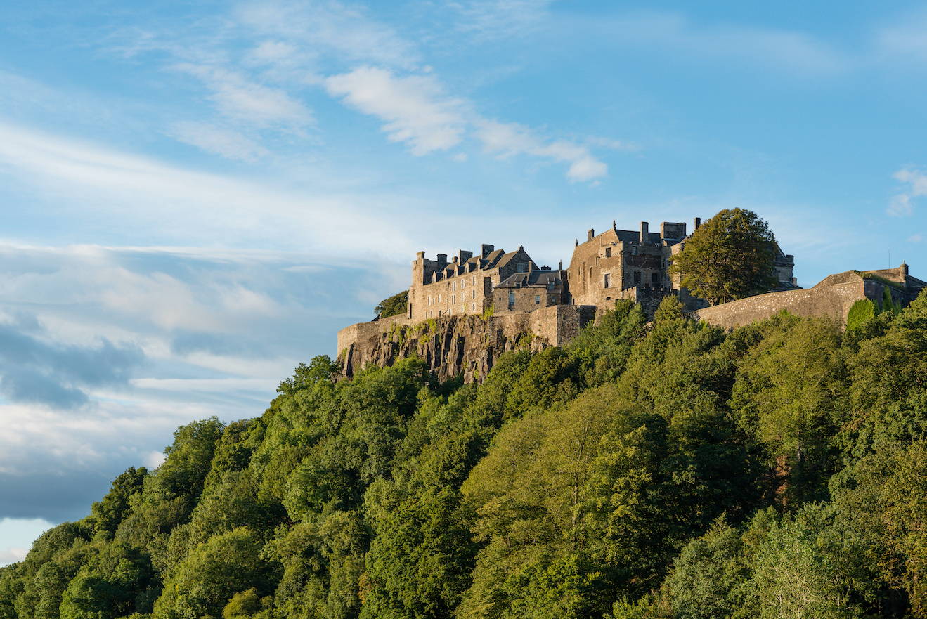 Looking up at the formidable Stirling Castle siting on top of a tree covered volcanic plug with views in all directions