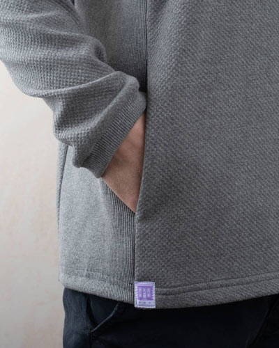 Hand in a pocket of grey Lyme Terrace organic cotton mens sweatshirt