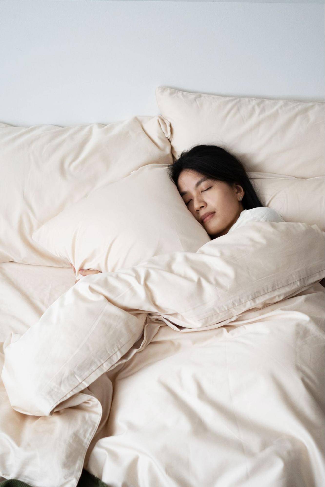 girl sleeping on Weavve's cotton cream colour bed sheet set 