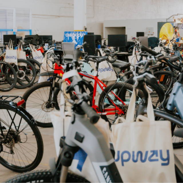 Upway UpCenter electric bike inventory with tote bags