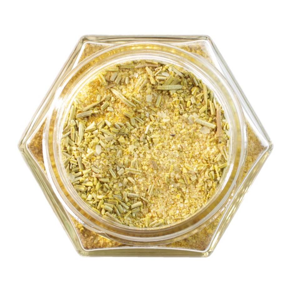 A single glass spice jar containing a yellowish green spice
